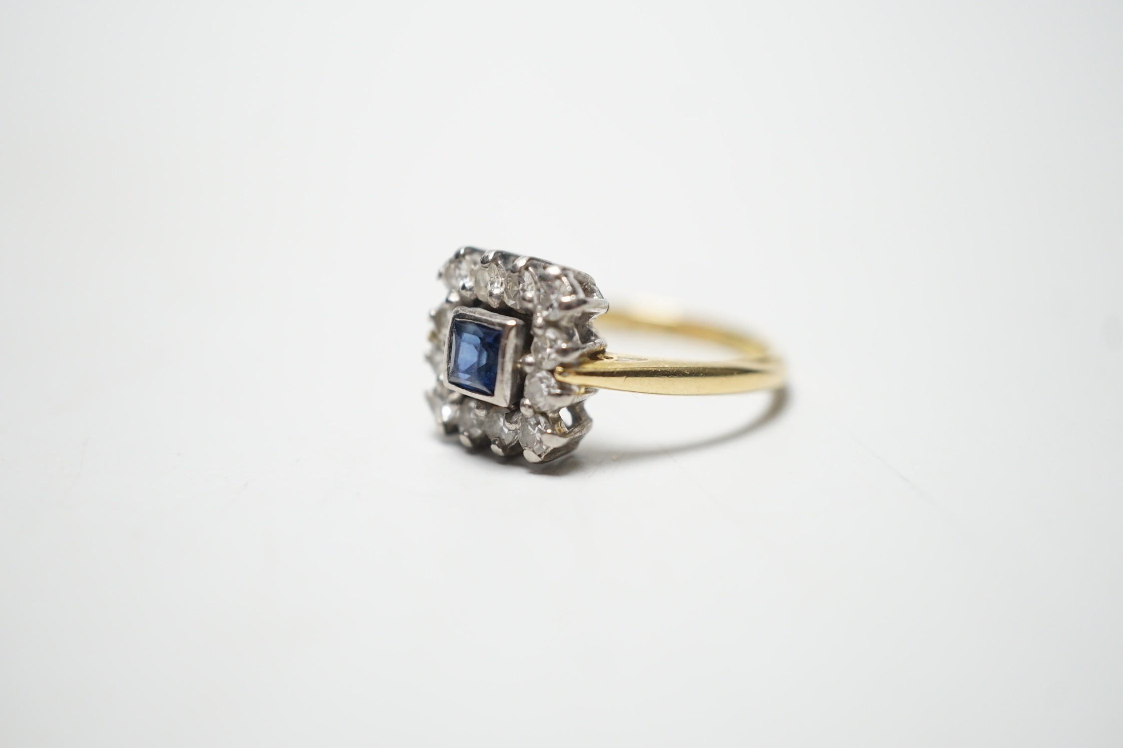 A 1960's 18ct gold, sapphire and diamond set square cluster ring, size N, gross 4.2 grams.